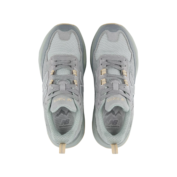 Pair of gray sneakers with gold accents on a white background