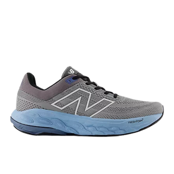 The New Balance Mens Fresh Foam 860v14 Wide in Grey/Blue features a mesh upper, large N logo, black laces, and a thick light blue sole with Fresh Foam X cushioning for added comfort and support.