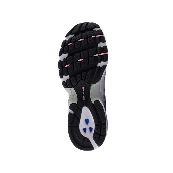The image displays the sole of a NEW BALANCE Unisex 530 White/Pink running shoe, featuring black tread with white and pink highlights and a textured grip pattern for support and comfort to help reduce foot pain.