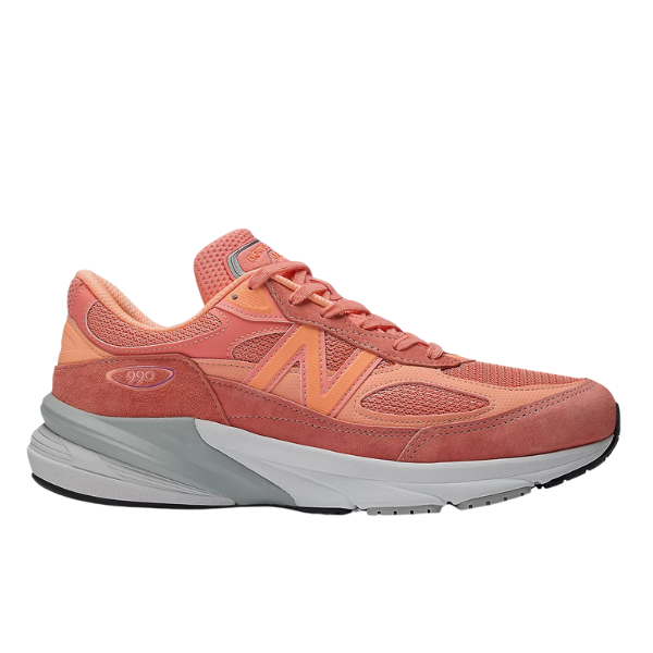 The New Balance Womens 990v6 Rose sneaker features coral pink and peach mesh and suede panels, gray midsole accents with FuelCell cushioning, plus a rubber outsole, shown in a side profile.