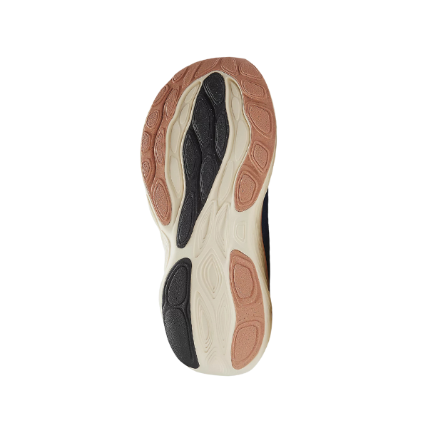The image shows the sole of the NEW BALANCE Womens Fresh Foam X 1080v14 Blue running shoe, with a wavy, textured black, tan, cream, and brown rubber pattern designed for comfort and foot pain relief on a white background.
