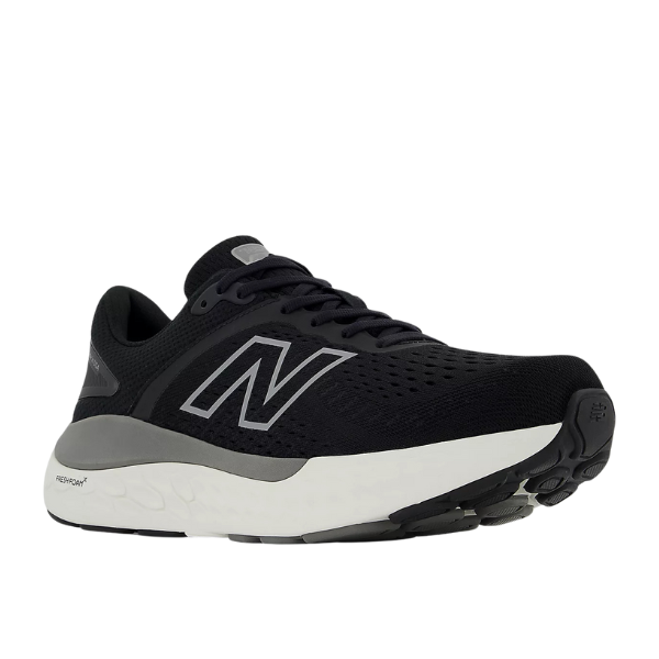 The New Balance Womens Fresh Foam X 1540v4 Wide in Black/White features a large white N logo, cushioned Fresh Foam X midsole, and black outsole, displayed at an angled side view on a white background.