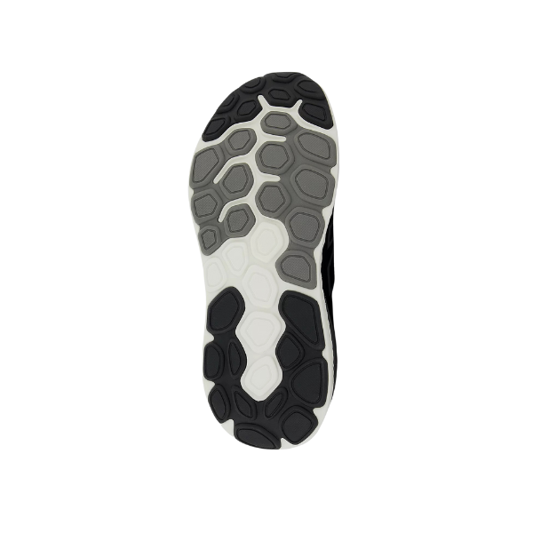 The image displays the sole of the New Balance Womens Fresh Foam X 1540v4 Wide Black/White shoe, featuring a hexagonal tread in black, grey, and white with Fresh Foam X cushioning, shown from the bottom on a white background.