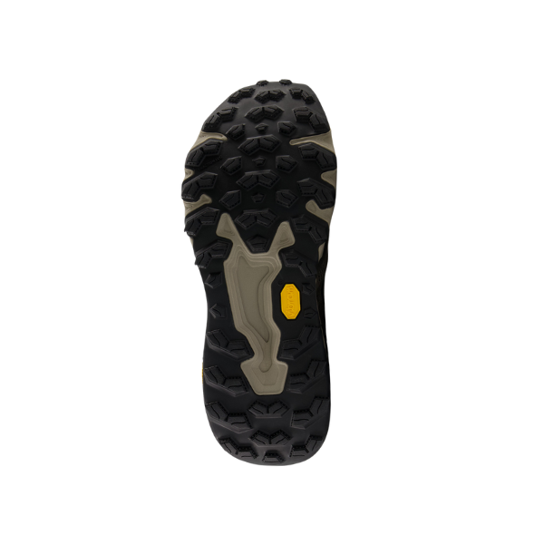 The image shows the bottom view of the New Balance Mens Fresh Foam X Hierro v9 Wide Grey by NEW BALANCE, featuring a rugged black and beige Vibram outsole with a yellow logo near the arch for outstanding grip and durability. The background is white.
