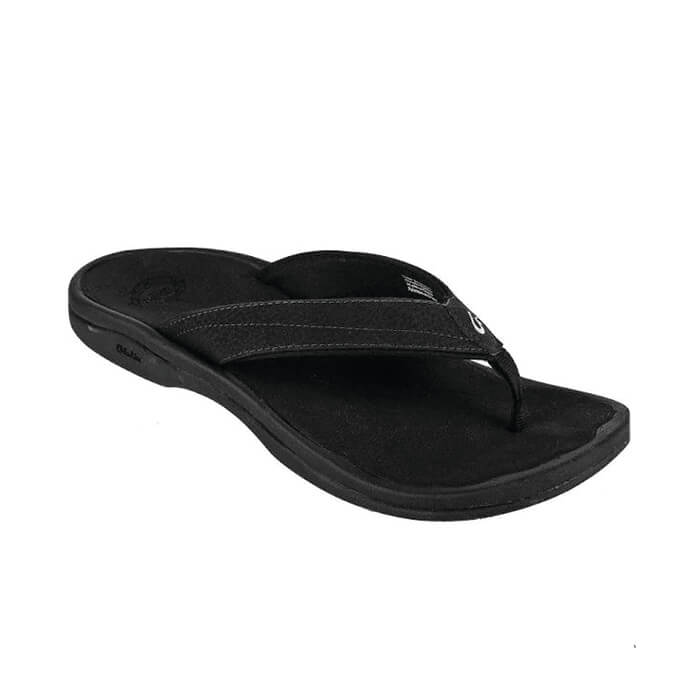 The OLUKAI Men's Ohana Black sandal features a thick strap and contoured sole for foot pain relief, shown against a white background.