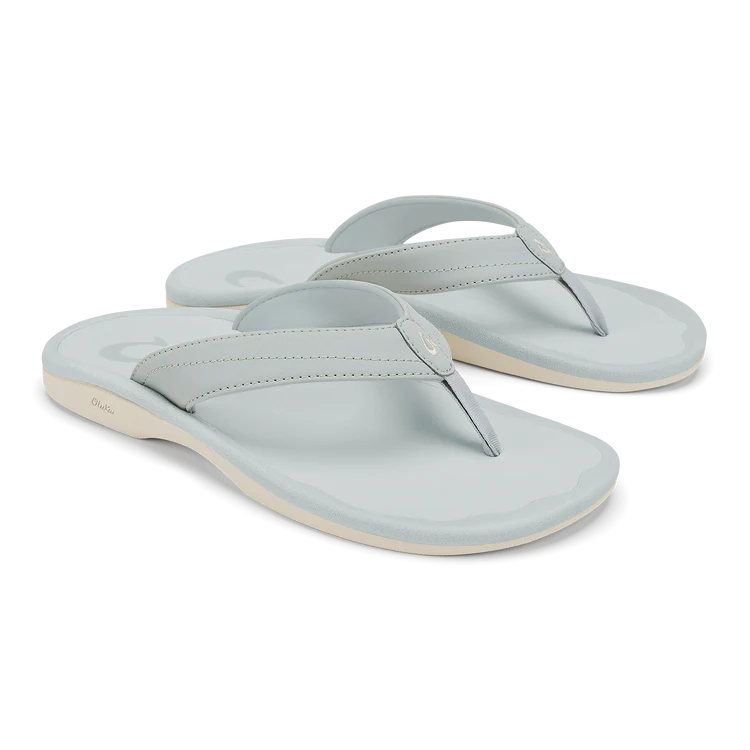 A pair of OLUKAI Womens Ohana sandals in Cloud Grey, featuring thick straps, an anatomical footbed, and white soles, displayed at an angle on a plain background.