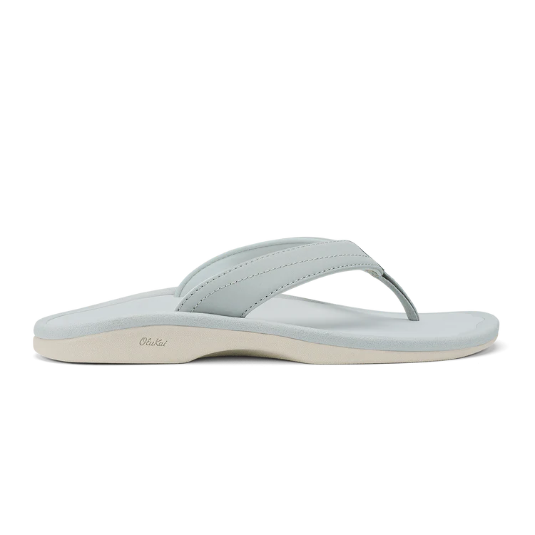 The OLUKAI Womens Ohana Cloud Grey sandal features a water-resistant design, anatomical contoured footbed, and a Wide thong strap, with the “Olukai” branding subtly displayed on the sole.