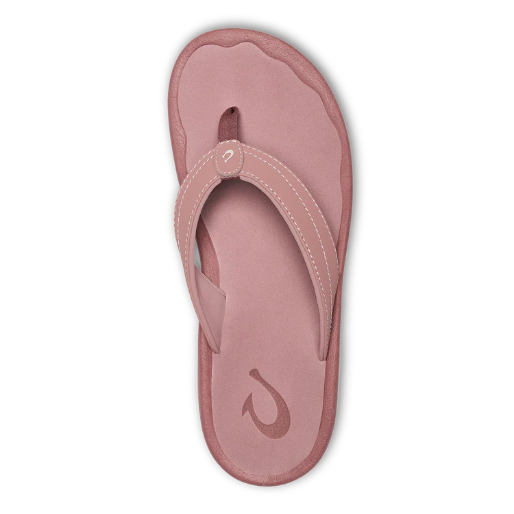 A single OLUKAI Womens Ohana Coral Rose flip-flop sandal is shown from above on a white background, featuring an anatomical footbed, textured sole, thick strap with white stitching, and logo on the footbed.