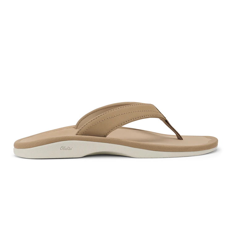 The OLUKAI Womens Ohana sandal in Warm Sand features cushioned anatomical footbeds, tan straps, and a white sole, shown in side profile on a plain white background.