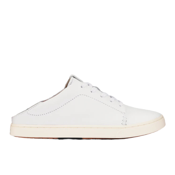 The OLUKAI Womens Pehuea Lī ‘Ili Leather White is a white leather slip-on court sneaker with a low back, lace-up front, and flat off-white rubber sole—crafted for comfort and ideal for those seeking relief from foot pain. Side view on plain background.