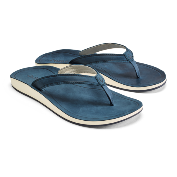 The OLUKAI Olukai Womens Southshore Indigo sandals are blue comfort sandals for women with white soles, a simple strap design, and a comfortable, slightly contoured footbed.