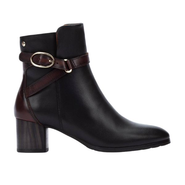 The PIKOLINOS Women’s Calafat Black ankle boot features a chunky mid-heel, brown strap with gold buckle, slightly pointed toe, and provides extra comfort for all-day wear.