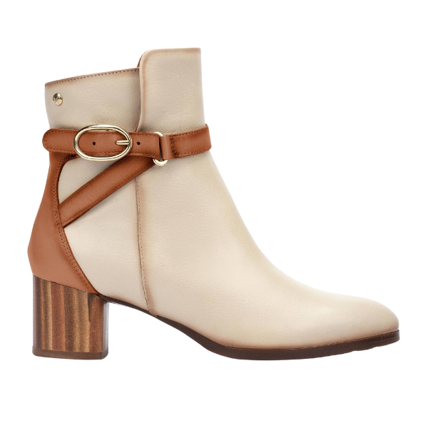 The PIKOLINOS Women’s Calafat Cream is a beige ankle boot featuring a medium block heel, brown leather strap and buckle at the ankle, crafted from soft calfskin with a brown patch at the heel for extra comfort.