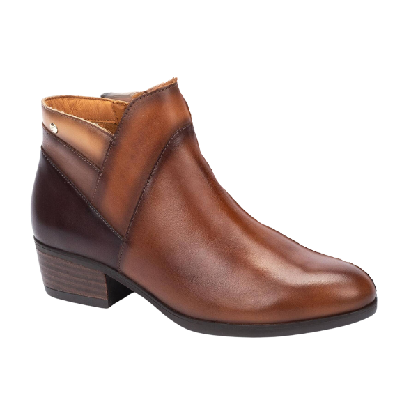 The PIKOLINOS Daroca Cuero is a brown womens ankle boot featuring a low stacked heel, slightly pointed toe, gradient light-to-dark brown color, subtle stitching, and a metallic accent near the ankle for standout style and comfort.