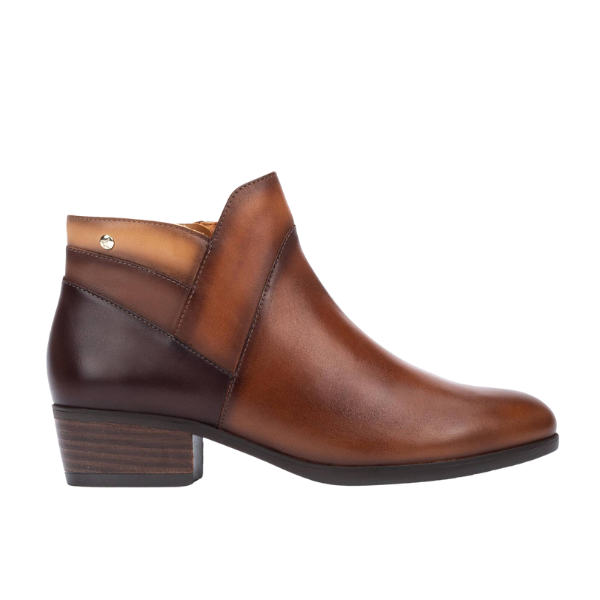 The PIKOLINOS Daroca Cuero is a womens brown ankle boot with a side zipper, gradient from dark to light brown, low heel, and metal stud detail for stylish comfort.