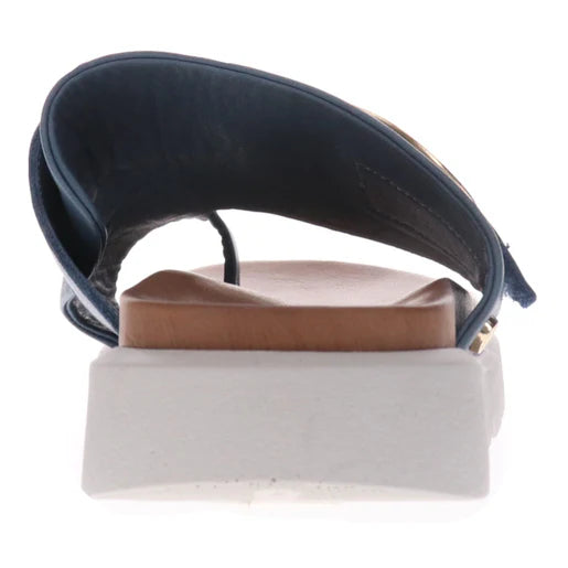 Rear view of the REVERE Womens Biscay Blue sandal shows its navy premium leather upper, tan anatomically designed footbed, and thick white sole with a supportive heel area.