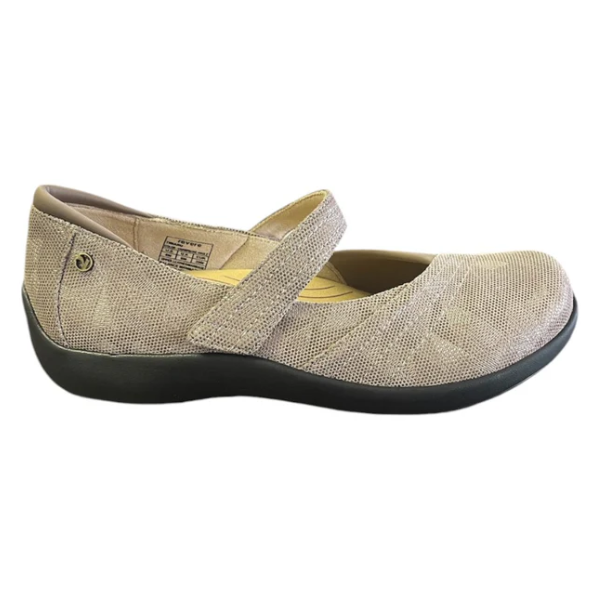 The REVERE Womens Timaru Mary Jane Champagne features a textured fabric upper in beige, single Velcro strap, and black rubber sole. Designed for orthotic comfort, theyre ideal womens shoes for all-day support. Shown in side profile.