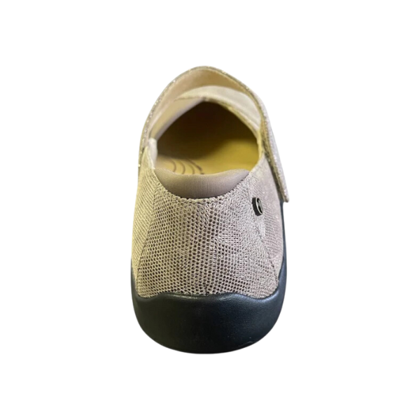 The REVERE Womens Timaru Mary Jane Champagne is a beige, textured slip-on shoe with a black rubber sole, designed for comfort like plantar fasciitis shoes, shown from the back against a white background.