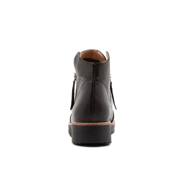 The DJANGO & JULIETT Womens Ohmy Black/Black bootie is shown from the back, highlighting its textured black leather, tan inner lining, black sole with light brown trim, and side zipper—comfort footwear perfect for all-day wear. Plain white background.