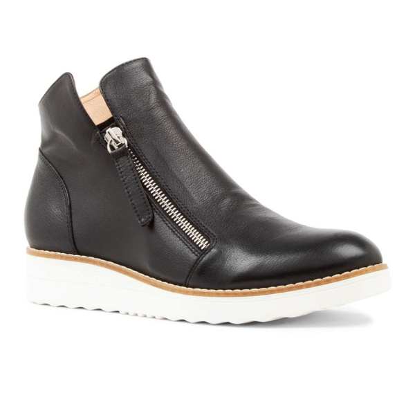 The DJANGO & JULIETT Ohmy Black/White bootie features black leather, a side zipper, white textured sole, and tan lining. Designed to help reduce plantar fasciitis pain. Seen from a slight angle.
