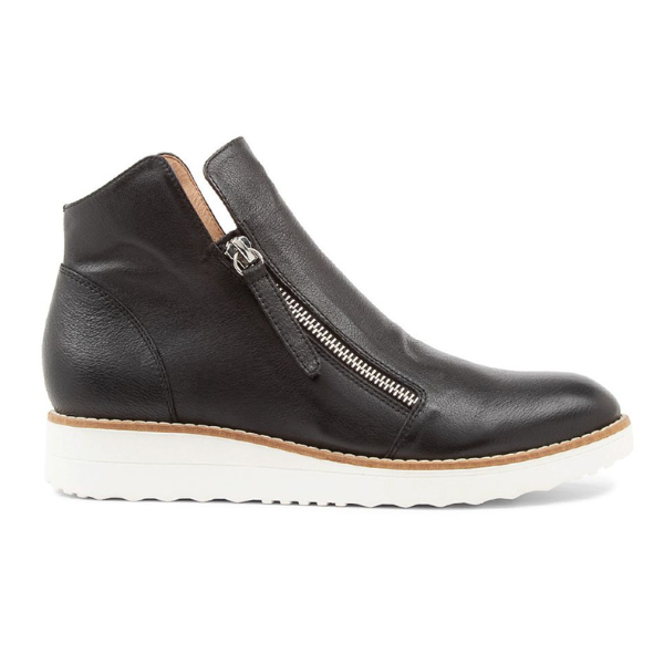 The DJANGO & JULIETTE Womens Ohmy Black/White is a black leather ankle bootie with a side zipper and white rubber sole, offering stylish comfort—ideal for relieving foot pain.