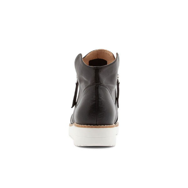 The Django & Juliette Womens Ohmy Black/White sneaker by DJANGO & JULIETT features a black leather high-top design, white rubber sole, and tan interior lining for comfort and support that helps reduce foot pain.
