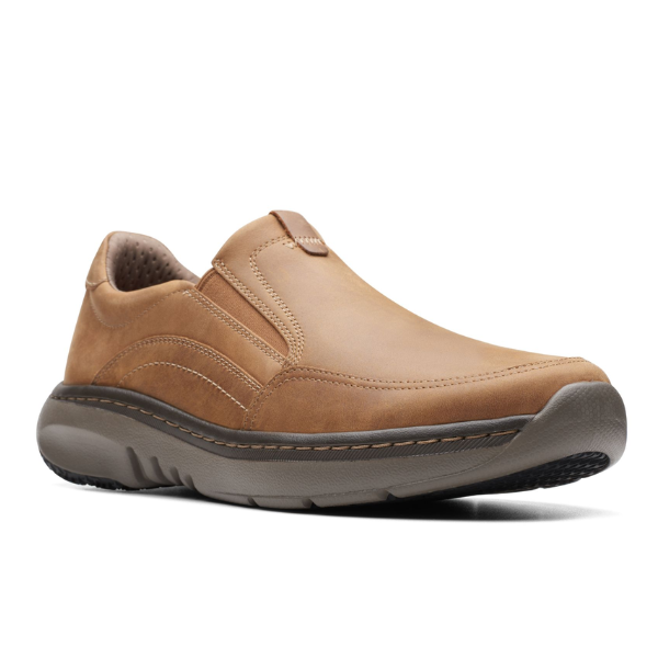 The Clarks Mens Pro Step Beeswax Leather slip-on features visible stitching, cushioned collar, removable insole, and a thick dark gray slip-resistant sole. It is shown at an angle on a white background.
