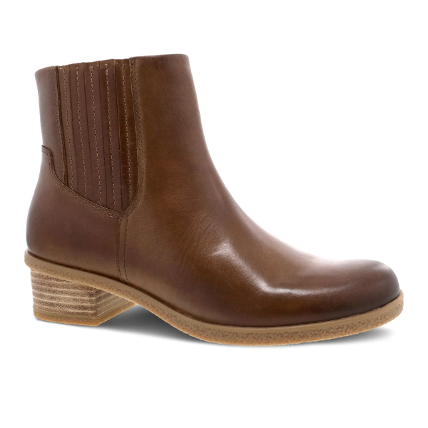 The Dansko Womens Daisie Waterproof Tan boot by DANSKO features brown leather, a low stacked heel, elastic side panel, rounded toe, and Natural Arch support for all-day comfort, shown on a white background.