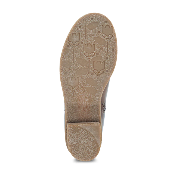 The image shows the sole of the DANSKO Womens Daisie Waterproof Tan boot, with a floral and leaf textured pattern, a slightly raised heel, and Dansko Natural Arch technology for enhanced support.