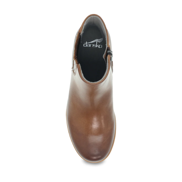 Top view of the DANSKO Womens Daisie Waterproof Tan, a brown leather ankle boot with a side zipper and rounded toe. Features Dansko Natural Arch support for comfort and the Dansko logo on the black insole.
