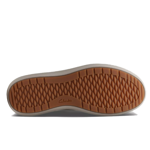 The image shows the sole of the Clarks Womens Nalle Lace Wide Black/White sneaker by CLARKS, with a light brown, textured rubber bottom featuring a diamond pattern and logo at the center. The sides of the sole are light beige.