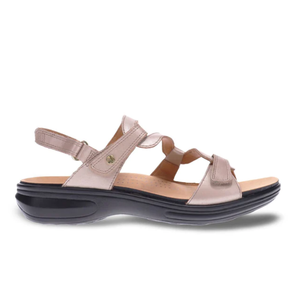 The Revere Womens Emerald Champagne sandal by REVERE features luxe beige leather, adjustable straps, a metallic button detail, and a black cushioned sole with slight heel—designed for comfort and support to help ease foot pain.