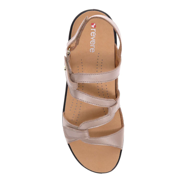 Top view of Revere Womens Emerald Champagne sandals by REVERE, crafted in luxe leather with three crossing straps and a cushioned tan footbed—designed for all-day comfort and relief from foot pain.