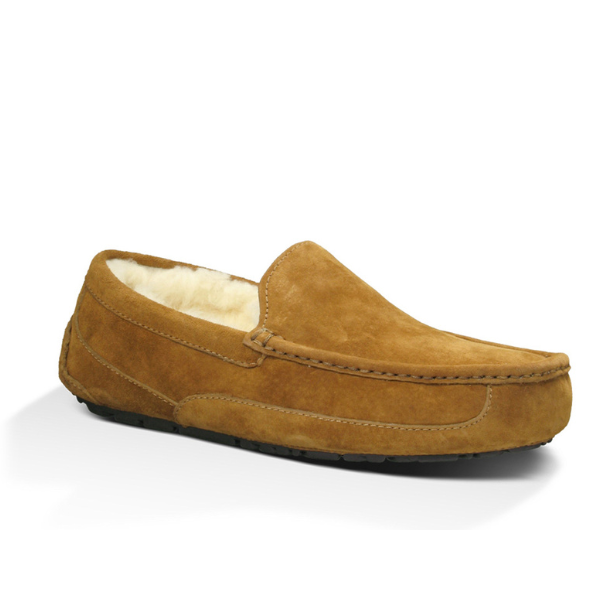 The UGG Mens Ascot Slipper Chestnut is a tan suede loafer with visible stitching, a plush cream lining, and a durable rubber sole for comfort and foot pain relief. Shown on a white background.