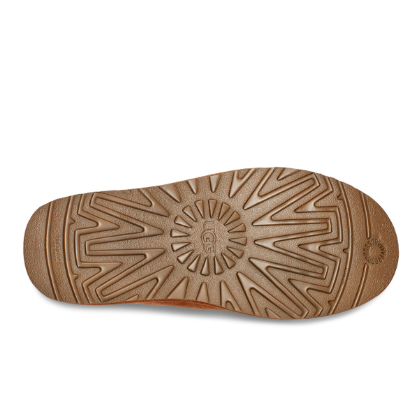 The UGG Mens Neuman Slipper Chestnut features a durable brown sole with a textured, patterned tread and central circular logo, crafted with Treadlite by UGG for superior comfort, support, and slip resistance.