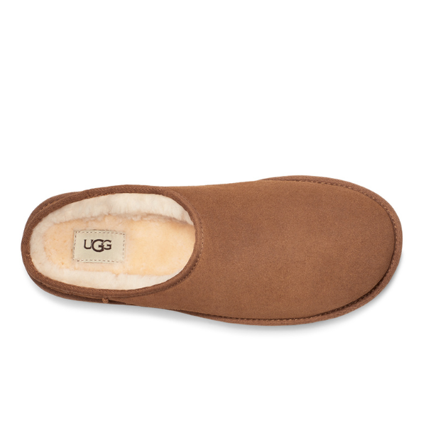 The UGG Mens Classic Slip-On Chestnut is a mens slip-on sheepskin slipper in brown suede with cream fleece lining, featuring an UGG brand label on the insole and shown from a top view.
