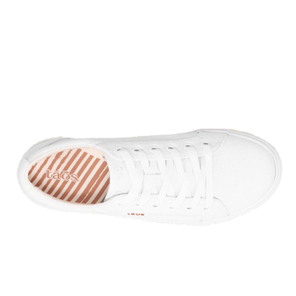 Top view of the TAOS Womens Plim Soul Lux White Leather sneakers with white laces, a pink-and-white striped insole featuring the taos logo, and built-in metatarsal support.