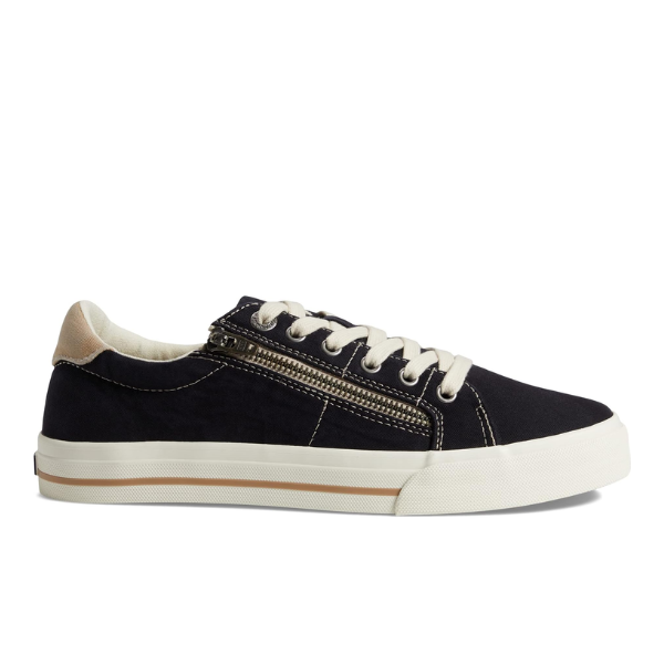 The TAOS Womens Z Soul Black/Tan Distressed is a black canvas sneaker with white laces and sole, tan heel accent, side zipper, and removable footbed. Shown in a side view on a plain white background.
