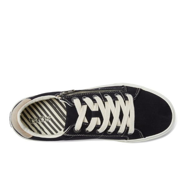 Top view of the Taos Womens Z Soul Black/Tan Distressed sneaker by TAOS, featuring white laces, a white sole, a striped black and white insole with the brand logo near the heel, and a removable footbed for customizable arch support.