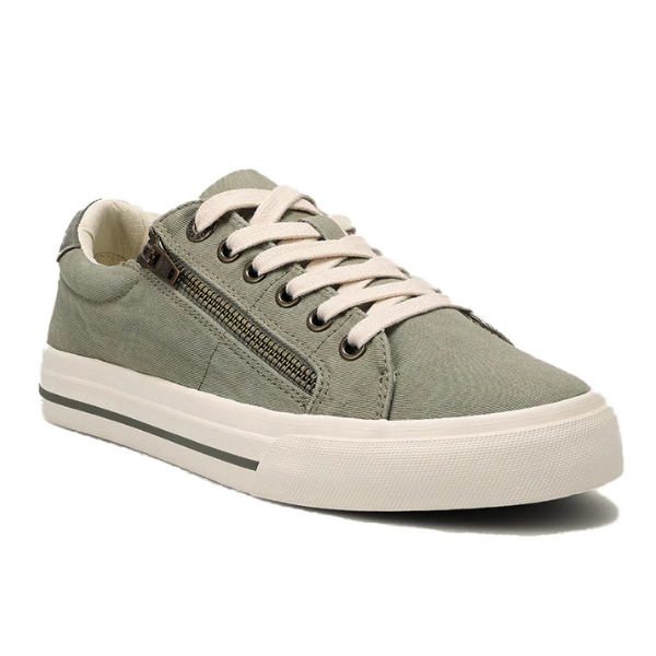 The TAOS Taos Womens Z Soul Sage/Olive Distressed sneaker features a light green color, white laces, a white rubber sole with grey midsole stripe, decorative side zipper, and removable footbed for personalized comfort.