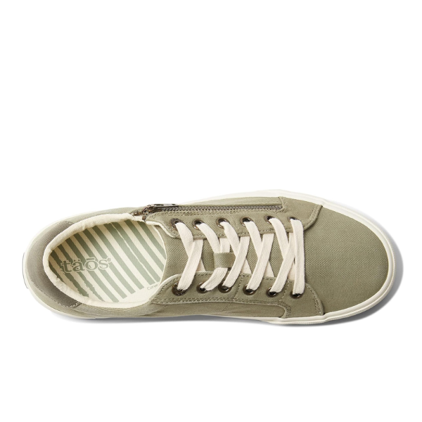 Top view of the Taos Womens Z Soul Sage/Olive Distressed sneaker by TAOS, featuring an olive green canvas upper, white laces, white sole, and a removable footbed with supportive arch and striped insole bearing the “taos” logo.