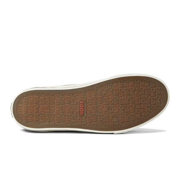 The image shows the bottom sole of the Taos Womens Z Soul Sage/Olive Distressed sneaker by TAOS, with a brown rubber tread featuring a repeating taos logo and a red taos logo at the center, plus a white outer edge and removable footbed.