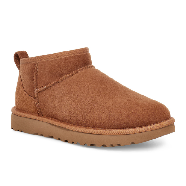 The UGG Womens Classic Ultra Mini Boot in Chestnut features brown suede, a rounded toe, visible stitching, a back pull tab, and a textured rubber sole for foot pain relief.