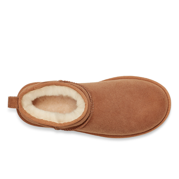 Top view of the UGG Womens Classic Ultra Mini Boot in Chestnut—a brown suede slipper with a rounded toe, beige fleece lining, and heel pull tab, blending cozy comfort and signature UGG style.