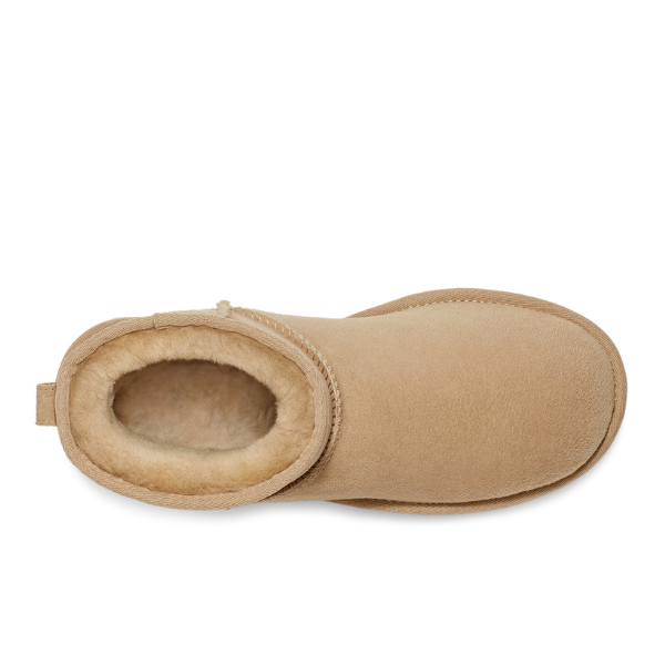 Top view of the UGG Womens Classic Mini II Boot in Mustard Seed, lined with soft light brown plush shearling. The visible sole and heel highlight its cozy comfort—ideal for relieving foot pain.