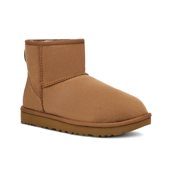 The UGG Womens Classic Mini II Boot in Chestnut features tan suede, a flat textured rubber sole, and visible stitching, designed for foot pain relief. Photographed against a white background.