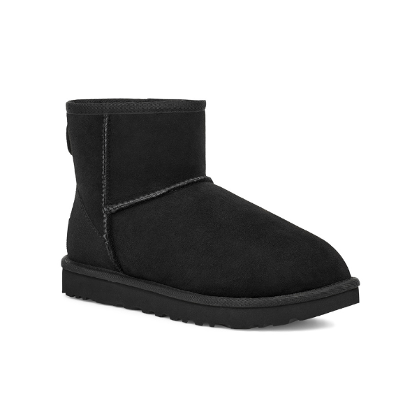 The UGG Womens Classic Mini II Boot in black, shown against a white background, features ankle-height suede with visible stitching, a thick textured sole, and is designed by UGG for foot pain relief.