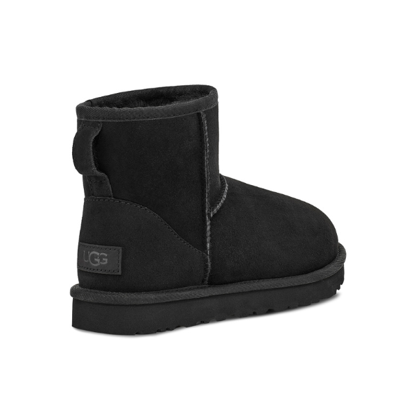 The UGG Womens Classic Mini II Boot in black features a plush lining, flat sole for comfort, a pull tab at the back, and an UGG label near the heel.