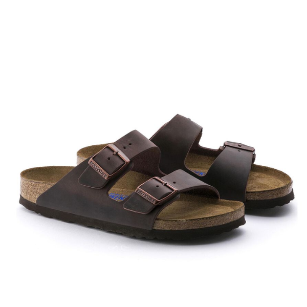 A pair of BIRKENSTOCK Womens Arizona Soft Footbed Oiled Leather Habana sandals with two adjustable buckle straps is shown side by side on a white background.