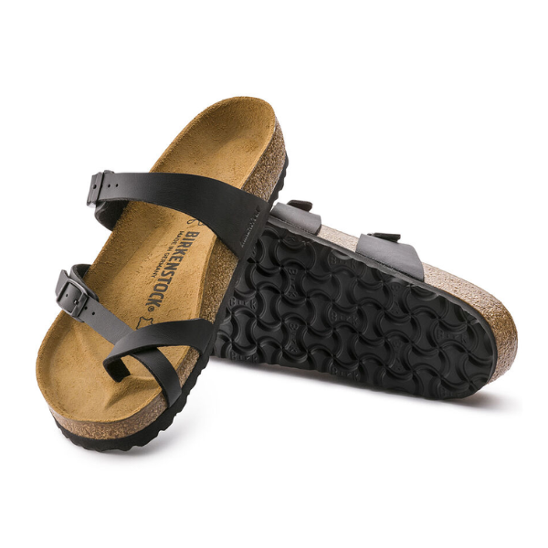 A pair of BIRKENSTOCK Womens Mayari Birko-Flor Black Leather sandals, one flat and one showing the textured sole, highlights their stylish look and cork footbed comfort.